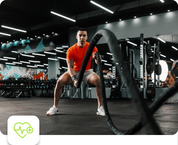 Man training with battle ropes in a gym